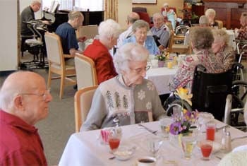 Seniors enjoying a good time in the dining room of 3801 Grand