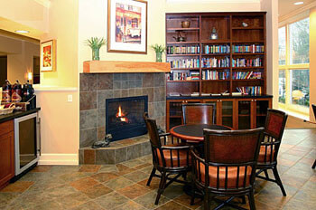 books, a fireplace and tables for the residents of this facility